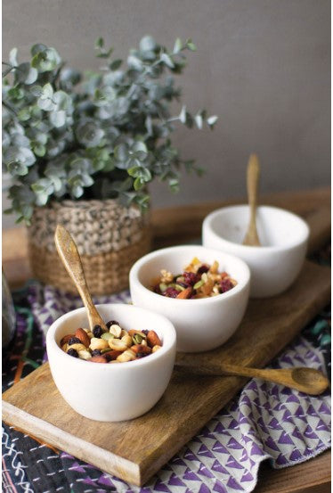 Three white stone serving bowls with wood tray